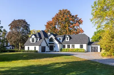 a large white house with a gambrel roof at Vineyard Estate by the River with Pool in Niagara on the Lake