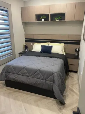 a bedroom with a bed and two plants on the wall at Modern 4 Bedroom Ground Floor Bungalow Style Home in Niagara Falls