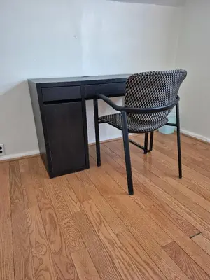 a chair sitting in front of a black desk at Cozy 3BR House Near Airport & Transit! in Mississauga