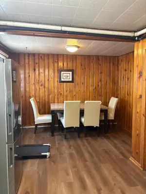 a dining room with a table and white chairs at Cozy 3BR House Near Airport & Transit! in Mississauga