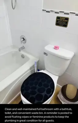 a bathroom with a toilet and a bathtub with a sign at Renovated 4-Bedroom Upper-Unit Detached House 5 Beds Near Toronto Pearson Airport in Toronto