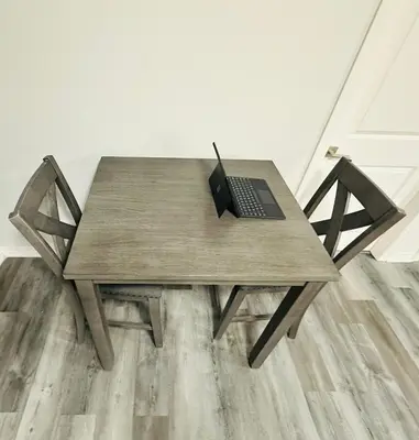 a wooden table with a laptop on top of it at Sky Cove - Modern Comfort, Simple, Cozy, Central in Saint Thomas