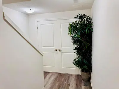 a hallway with a white door and a plant at Sky Cove - Modern Comfort, Simple, Cozy, Central in Saint Thomas