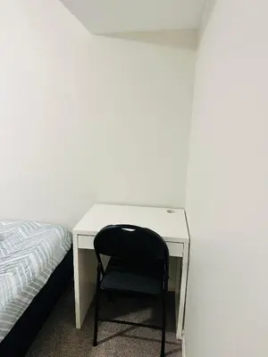 a desk with a black chair next to a bed at Sky Cove - Modern Comfort, Simple, Cozy, Central in Saint Thomas