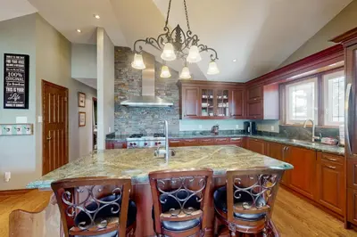 a kitchen with a large island with bar stools at Main House in Wasaga Beach