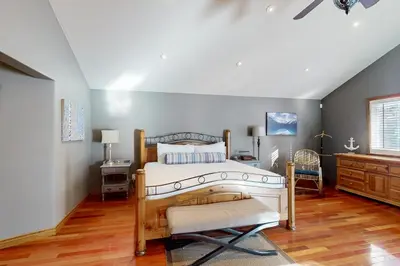 a bedroom with a bed and a desk and a dresser at Main House in Wasaga Beach