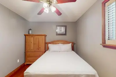 a bedroom with a bed and a ceiling fan at Main House in Wasaga Beach