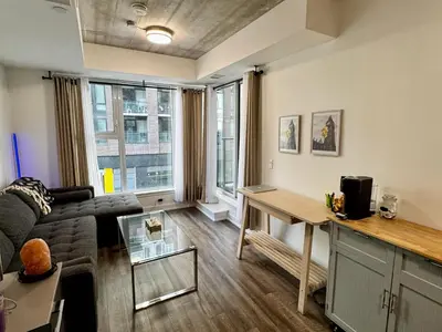 a living room with a couch and a table at Condo in the heart of toronto in Toronto