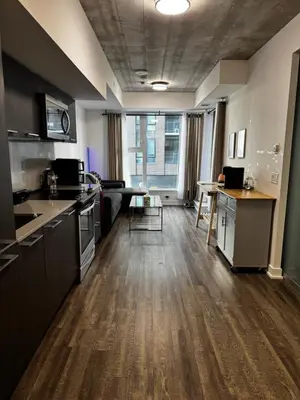a large kitchen with a counter and a table at Condo in the heart of toronto in Toronto