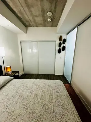 a bedroom with a large bed in a room at Condo in the heart of toronto in Toronto