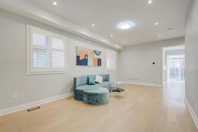 a living room with a blue couch and a table at Vantage stay Stouffville 4BR Bright Home in Stouffville