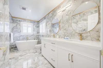 a white bathroom with a tub and a sink and a mirror at Vantage stay Stouffville 4BR Bright Home in Stouffville