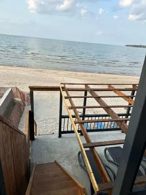a view of the beach from the porch of a house at Beach Front Family Cottage Ping Pong & Karaoke in Fort Erie
