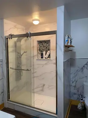 a shower with a glass door in a bathroom at Cottage on Crystal Beach 3BR & BBQ in Fort Erie