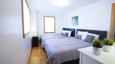a bedroom with two large beds in it at Cottage on Crystal Beach 3BR & BBQ in Fort Erie