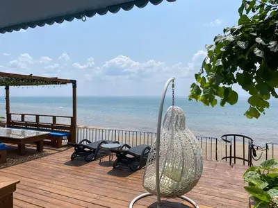 a view of the beach from the deck of a house at Water Front Beach House - 3BR w BBQ & Sunset in Fort Erie