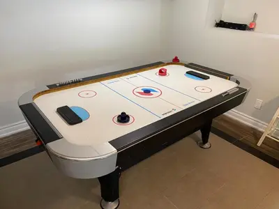 a pool table with a game on top of it at Water Front Beach House - 3BR w BBQ & Sunset in Fort Erie