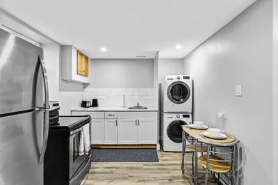 a kitchen with a refrigerator and a washer and dryer at NEW 5 Bedroom House Near The Falls in Niagara Falls