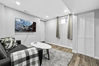 a living room with a couch and a table at NEW 5 Bedroom House Near The Falls in Niagara Falls