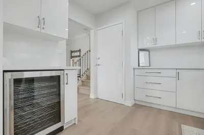 a kitchen with white cabinets and a fireplace at New 3BR Home - Minutes to the Falls in Niagara Falls