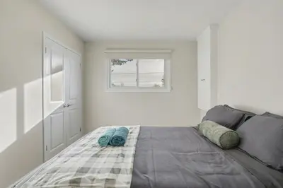 a bedroom with a bed with two blue towels on it at New 3BR Home - Minutes to the Falls in Niagara Falls
