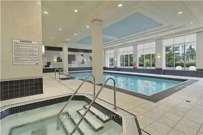a large swimming pool in a large building at Entire Place With Pool Sauna in Vaughan