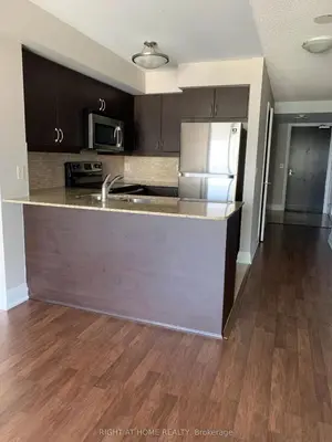 an empty kitchen with a sink and a refrigerator at Entire Place With Pool Sauna in Vaughan