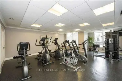 a gym with several treadmills and exercise bikes at Entire Place With Pool Sauna in Vaughan