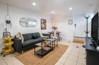 a living room with a couch and a table at Basement Suite for 2 w Private Patio in Toronto in Toronto