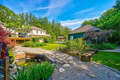 a backyard with a pond and a house at Charlotte Garden Bed and Breakfast in Niagara on the Lake
