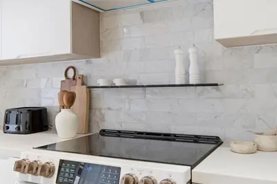 a kitchen with a stove top oven in a kitchen at The Brick Hotel - The Laneway in Toronto