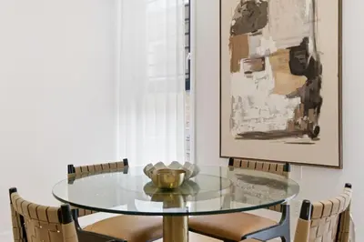 a glass table and chairs in a dining room at The Brick Hotel - The Laneway in Toronto