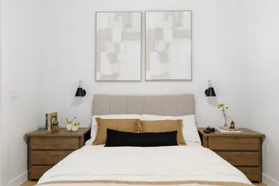 a bedroom with a large bed with two night stands at The Brick Hotel - The Laneway in Toronto