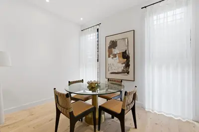 a dining room with a glass table and chairs at The Brick Hotel - The Laneway in Toronto