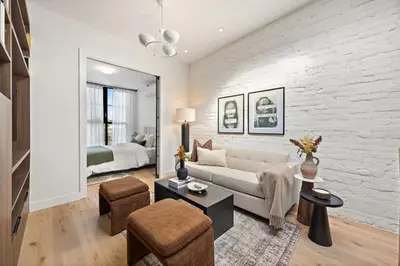 a living room with a couch and a bedroom at The Brick Hotel - The Loft in Toronto