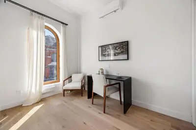 a desk and chair in a room with a window at The Brick Hotel - The Loft in Toronto