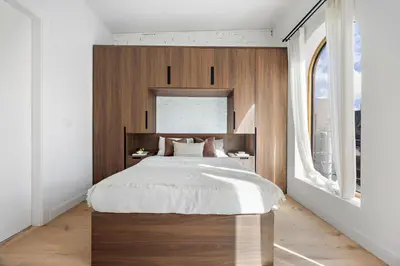 a bedroom with a large bed with a wooden headboard at The Brick Hotel - The Loft in Toronto