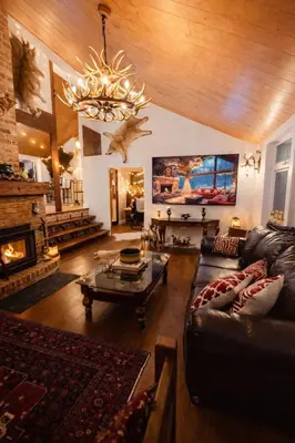 a large living room with a couch and a chandelier at Luxury Forest Retreat Near Mansfield Ski Club in Mulmur