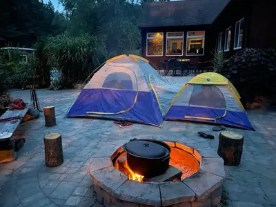 two tents are set up next to a campfire at Luxury Forest Retreat Near Mansfield Ski Club in Mulmur