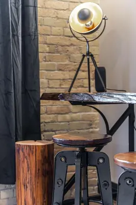a desk with a lamp next to a brick wall at Bradshaw Lofts The Brixton King Suite in Stratford