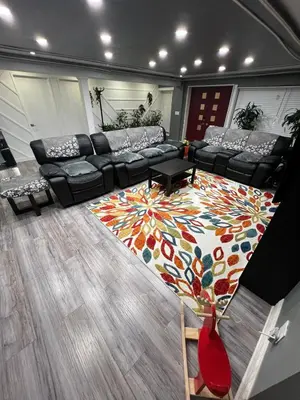 a living room with a couch and a colorful rug at Nature & Comfort - Private Manor in Innisfil