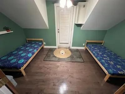a room with two beds and a hat on the floor at Nature & Comfort - Private Manor in Innisfil