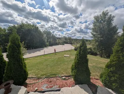 a view of a park with trees and a road at Nature & Comfort - Private Manor in Innisfil