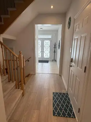 a hallway of a home with a door and a rug at Short Term Cozy Stay in Beautiful Fergus in Fergus
