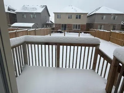 a balcony covered in snow in a neighborhood at Short Term Cozy Stay in Beautiful Fergus in Fergus