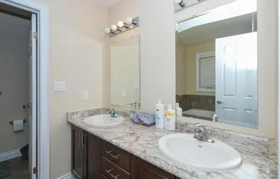 a bathroom with two sinks and a large mirror at Entire home in London, Ontario, Canada in London