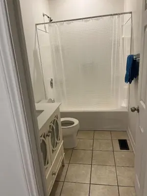 a white bathroom with a toilet and a shower at Places to stay bbq ac heat parking wiffi in Kawartha Lakes