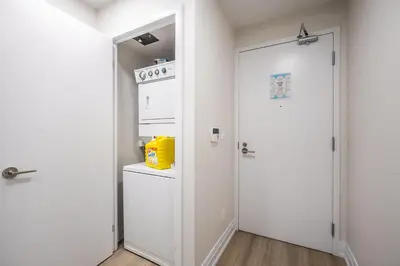 a kitchen with a white refrigerator and a door at Modern 1Bedroom Condo with Balcony Downtown Toronto in Toronto