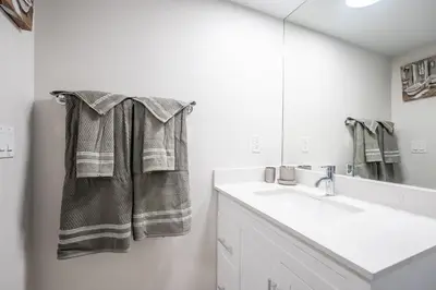 a bathroom with a sink and a mirror at Modern 1Bedroom Condo with Balcony Downtown Toronto in Toronto