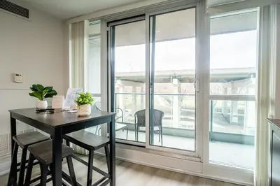 a dining room with a table and a large window at Modern 1Bedroom Condo with Balcony Downtown Toronto in Toronto